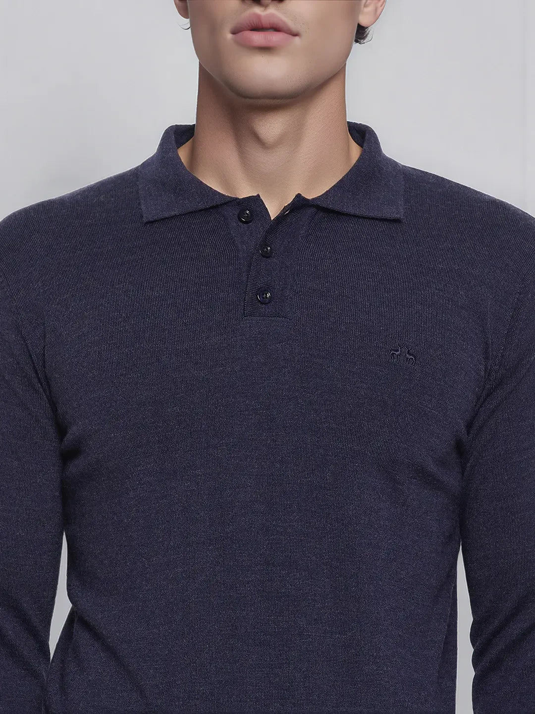 Man in a 98degreenorth Men’s Dark Denim Merino Wool Polo Neck Sweater, a smart casual handcrafted pullover.