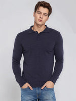 A man wears the 98degreenorth Men’s Dark Denim Merino Wool Polo Neck Sweater, a smart casual handcrafted pullover.