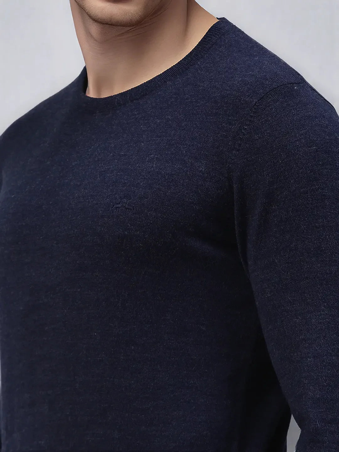 Man wears 98degreenorth Men’s Dark Denim Merino Wool Round Neck Sweater, a luxury handcrafted winter knit pullover.