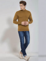 Man wearing 98degreenorth Men’s Dark Khaki Merino Wool Turtle Neck Sweater, blue jeans, and beige sneakers.
