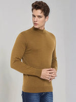 A young man wears a 98degreenorth Men’s Dark Khaki Merino Wool Turtle Neck Sweater, looking to the side.