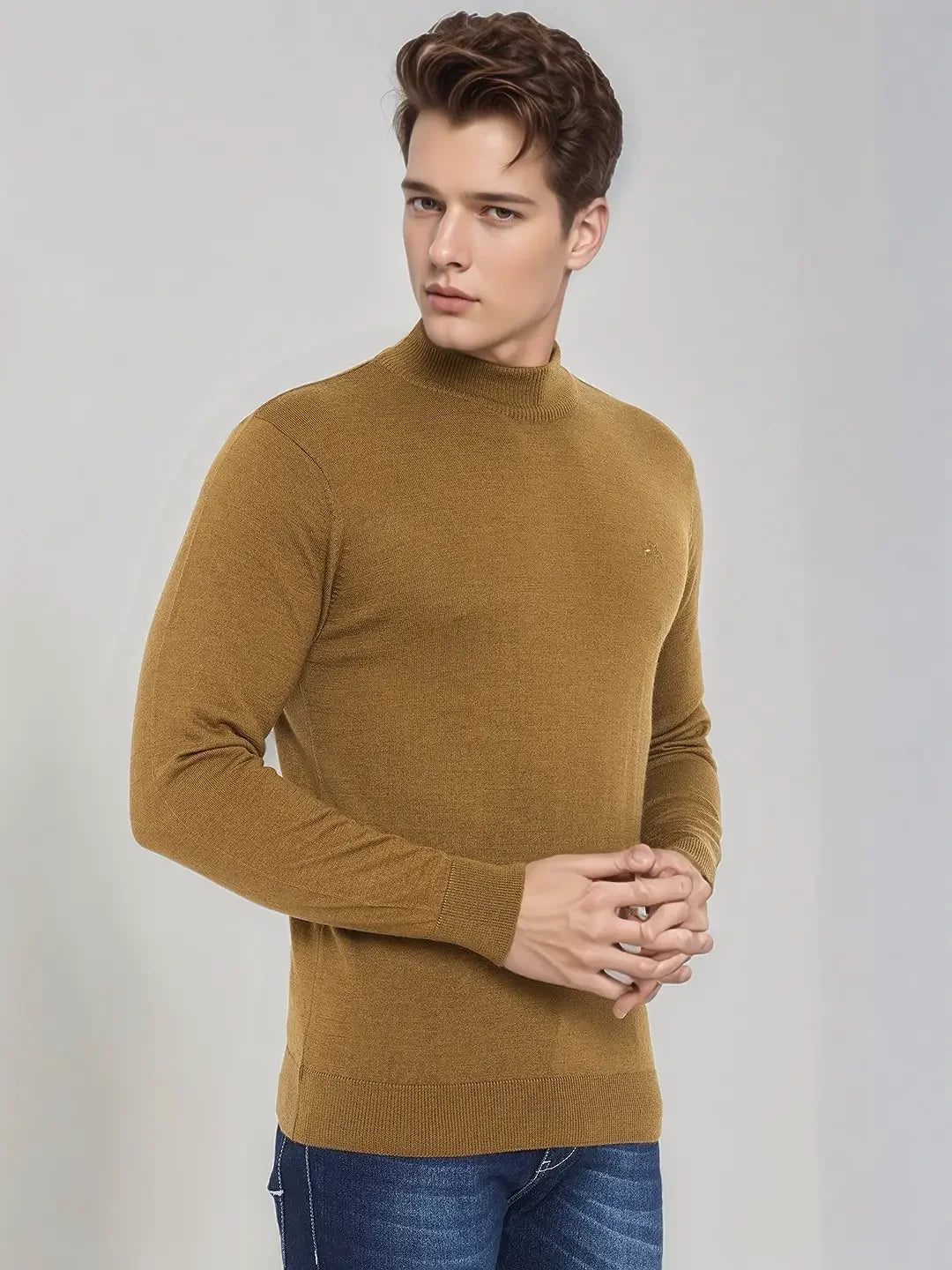 A young man wears a 98degreenorth Men’s Dark Khaki Merino Wool Turtle Neck Sweater, looking to the side.