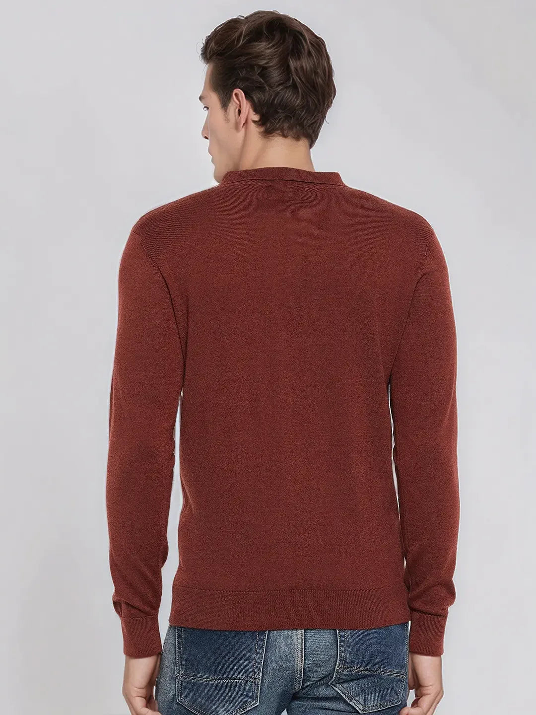 Man wears 98degreenorth Men’s Dark Maroon Merino Wool Polo Neck Sweater, standing with his back to a plain background.