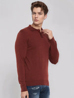 Young man in a 98degreenorth Men’s Dark Maroon Merino Wool Polo Neck Sweater and blue jeans on a light gray background.