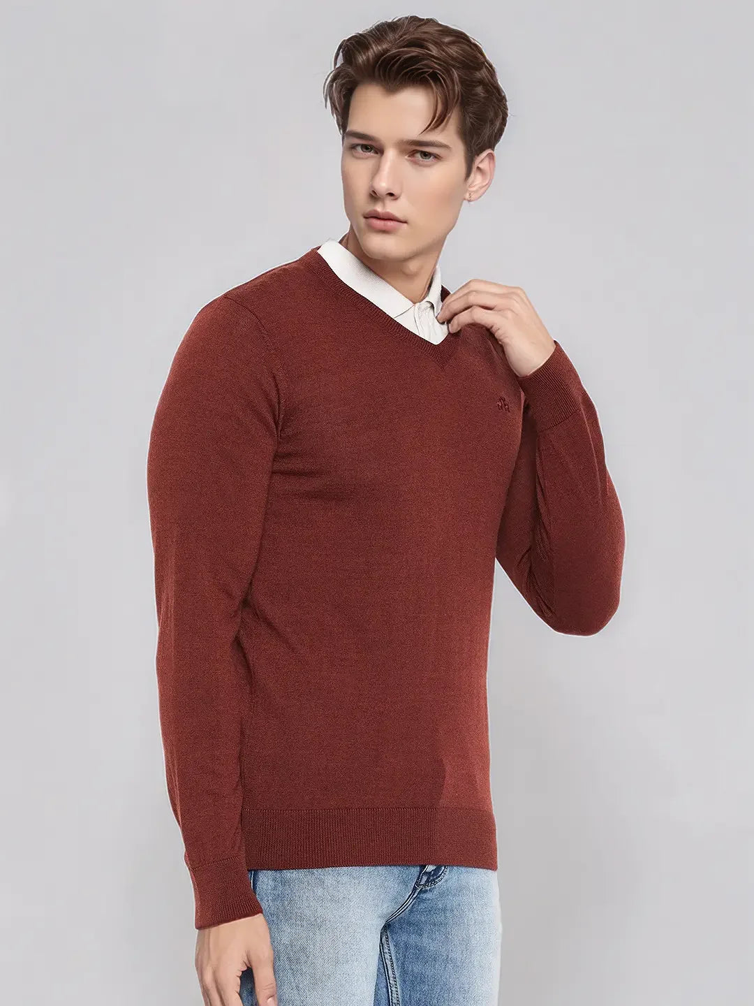 A man models the 98degreenorth Men’s Dark Maroon Merino Wool V-Neck Sweater, perfect for formal meetings and events.