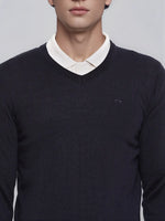A man wears a 98degreenorth Dark Navy Merino Wool V-Neck Sweater over a white shirt, shown shoulders to mouth.