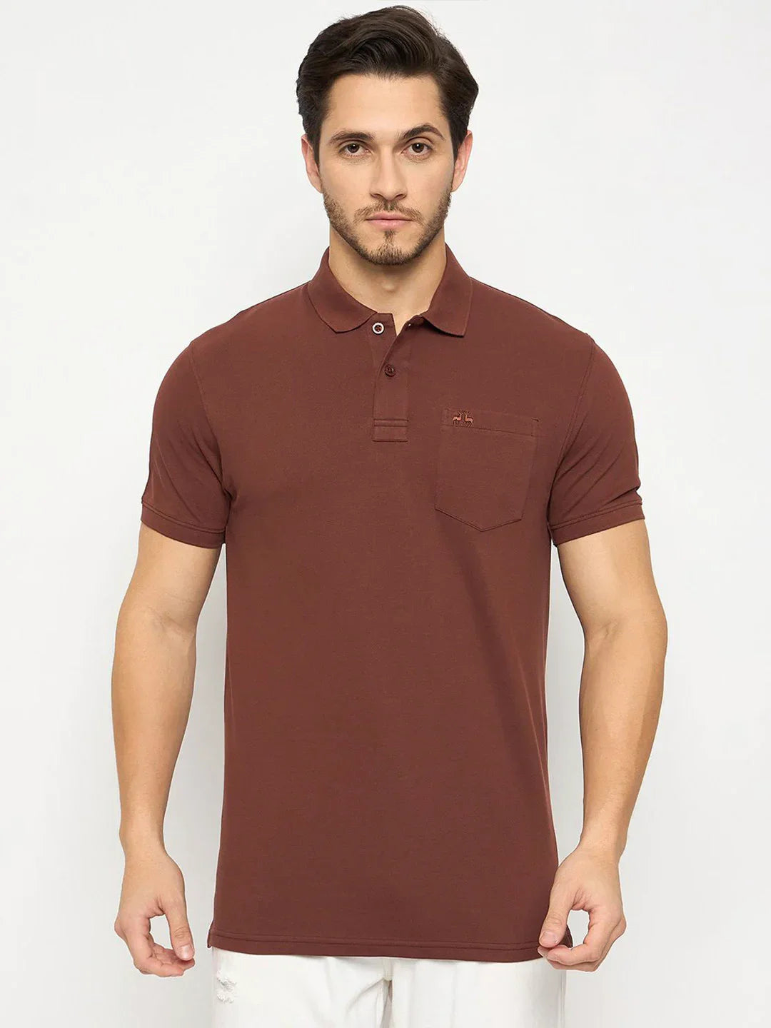 Man wears 98degreenorth Men's Dark Rust Polo T-Shirt—Stretch Cotton Pique with chest pocket, against white background.