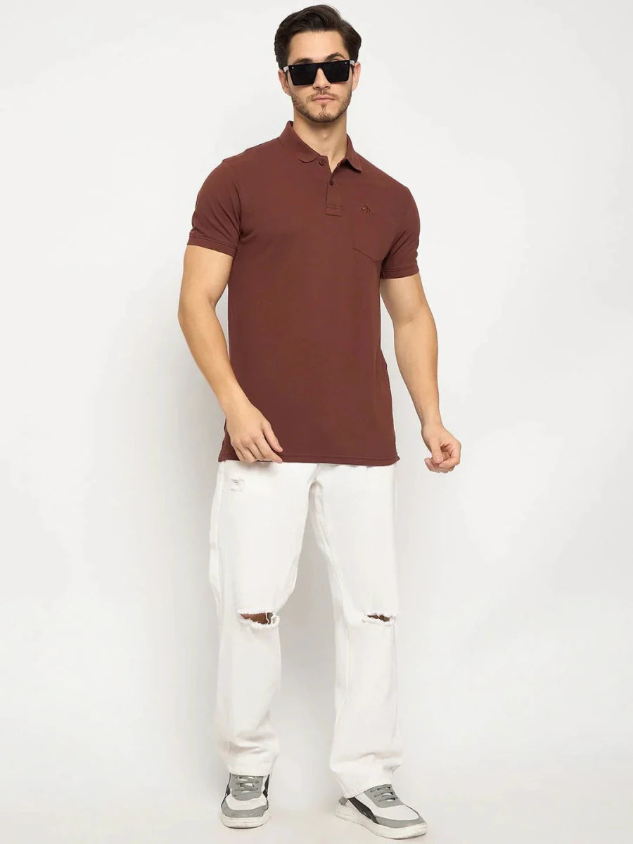 Man in 98degreenorth dark rust stretch cotton pique polo with chest pocket, white ripped jeans, and gray sneakers.