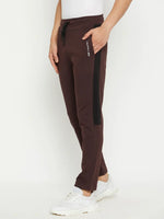 Wearing 98degreenorth Men’s Dark Wine Fleece Trackpants with side panel, white sneakers, and a white top—winter ready.