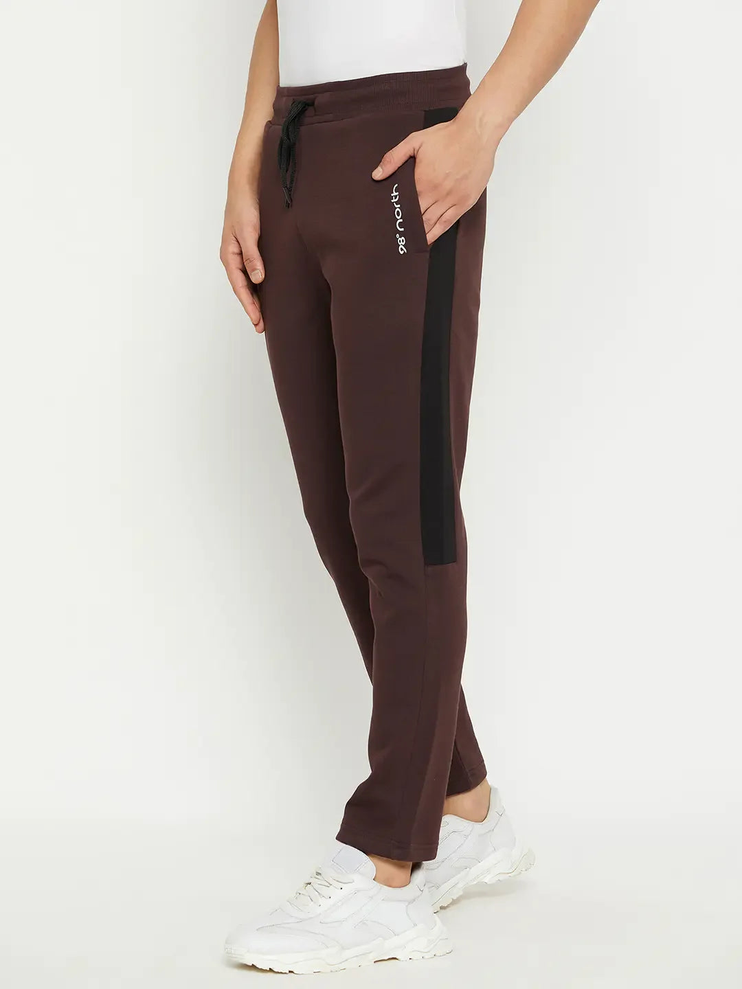Wearing 98degreenorth Men’s Dark Wine Fleece Trackpants with side panel, white sneakers, and a white top—winter ready.