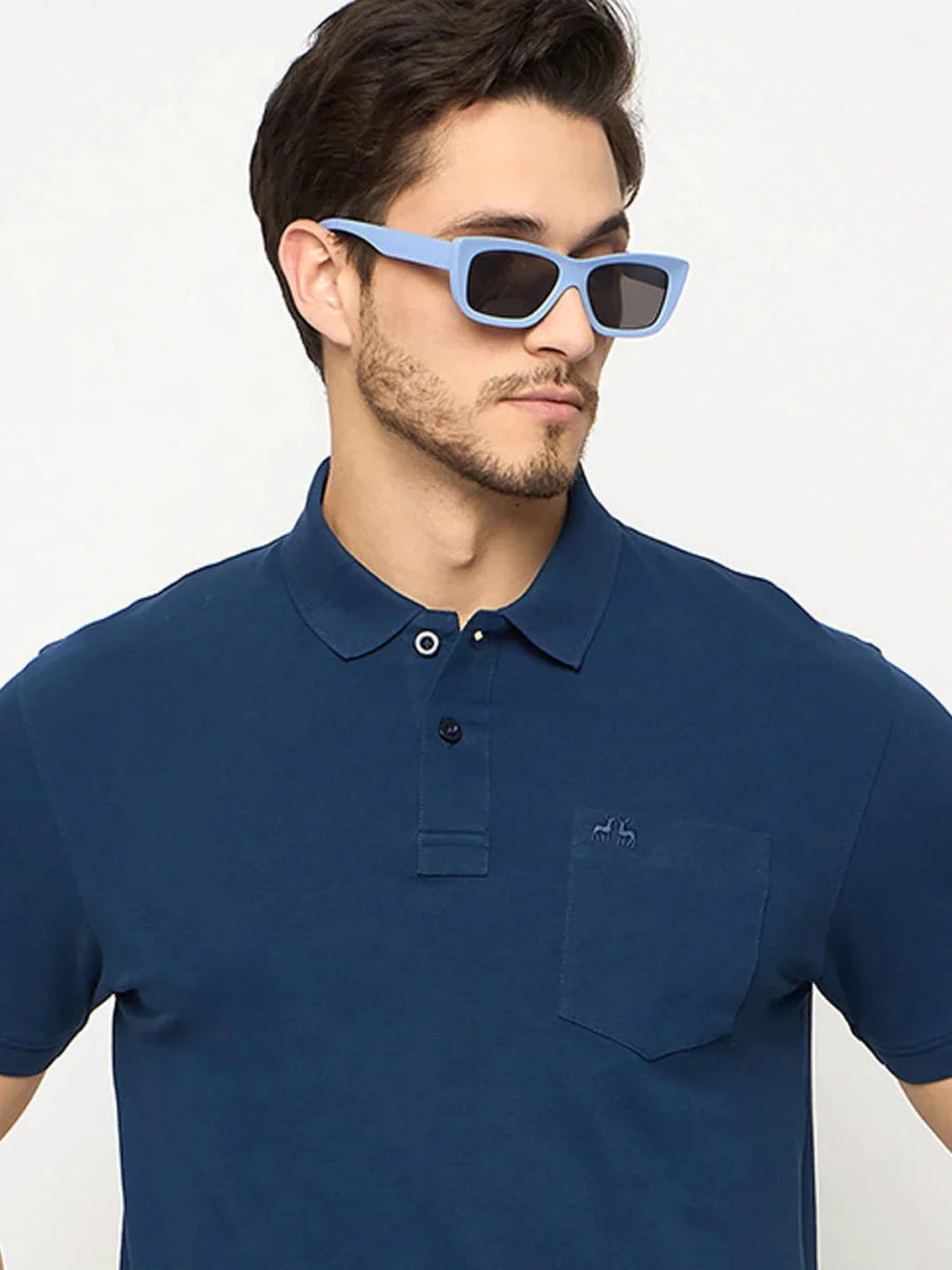 Man in 98degreenorth Men's Denim Blue Polo T-Shirt, pure cotton with chest pocket, looking sideways.