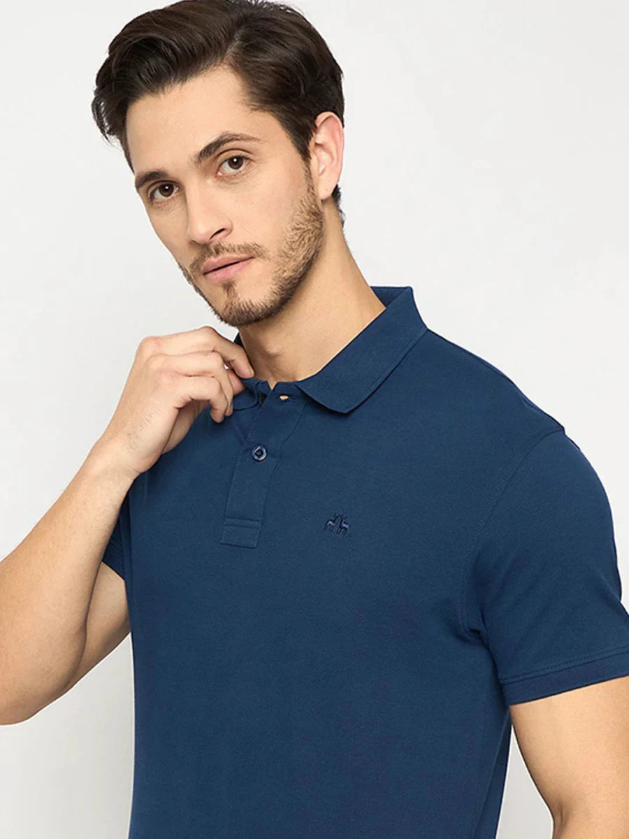 Man in a 98degreenorth Men's Denim Blue Solid Polo T-Shirt poses against a plain background.