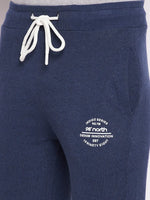 Close-up of 98degreenorth Men’s Denim Fleece Trackpants with white drawstring and logo on left thigh.