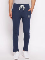 Man wearing 98degreenorth Men’s Denim Fleece Trackpants – trendy knit joggers for travel & fitness, against a plain background.