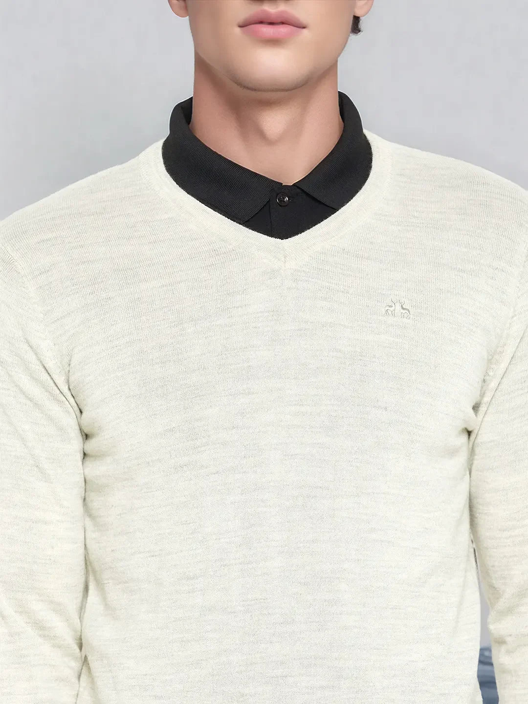 Man in 98degreenorth Men’s Ecru Merino Wool V-Neck Sweater over black shirt, shown shoulders to mouth.