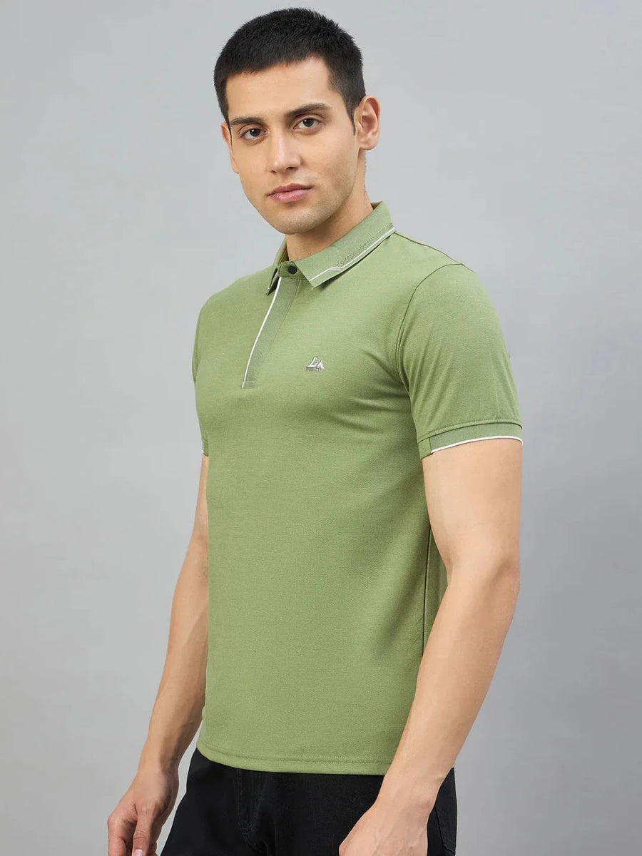Man in 98degreenorth Men's Green Polo T-Shirt with White Tipping and LA Logo, set against a grey background.