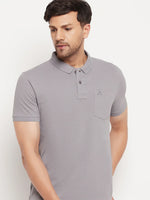 Man wears 98degreenorth Men's Grey Polo T-Shirt in stretch cotton pique with chest pocket, against white background.