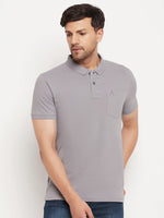 Man wears 98degreenorth Men's Grey Polo T-Shirt in stretch cotton pique with chest pocket—a wardrobe essential.