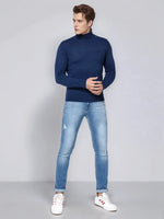 Man wears 98degreenorth Light Denim Merino Wool Turtle Neck Sweater, soft knit for modern winter looks.