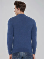 Man with short brown hair wears a 98degreenorth Men’s Light Denim Merino Wool Turtle Neck Sweater and jeans, facing away.