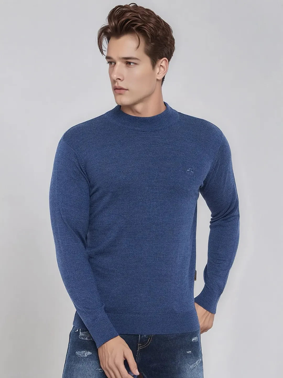 A man in a 98degreenorth Men’s Light Denim Merino Wool Turtleneck Sweater in India.