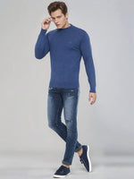 A man in a 98degreenorth Men’s Light Denim Merino Wool Turtle Neck Sweater, perfect for winter in India.