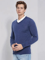 A man models the 98degreenorth Light Denim Merino V-Neck Sweater, styled smart casual over a white shirt.
