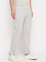 Model wears 98degreenorth Men's Light Grey French Terry Lycra Trackpants, perfect for summer athleisure and comfort.