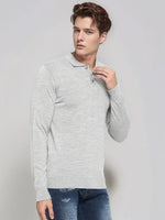 Man in 98degreenorth Men’s Light Grey Merino Wool Polo Sweater and blue ripped jeans, against a plain light background.