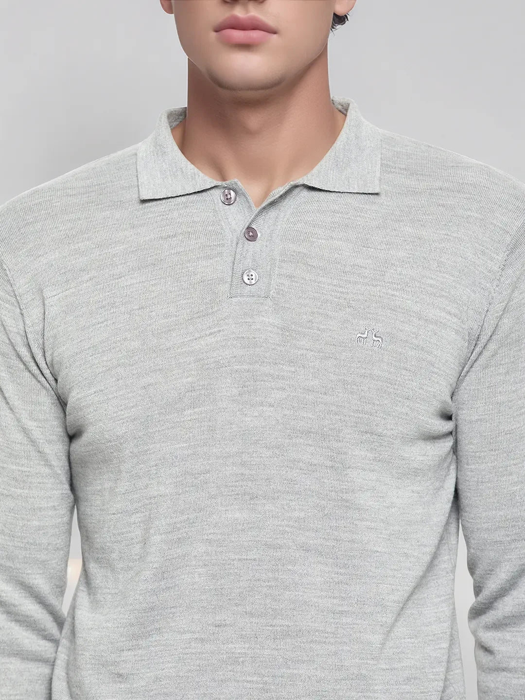 A person wears the 98degreenorth Men’s Light Grey Merino Wool Polo Sweater, a versatile winter pullover with logo.