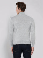 Man wears 98degreenorth Men’s Light Grey Merino Wool Turtle Neck Sweater with dark jeans, back to camera.