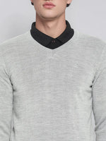 A man wears the 98degreenorth Men’s Light Grey Merino Wool V-Neck Sweater over a black shirt, shown shoulders to mouth.