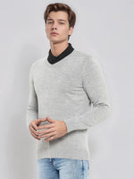A man wears a 98degreenorth Men’s Light Grey Merino Wool V-Neck Sweater, standing against a plain light background.