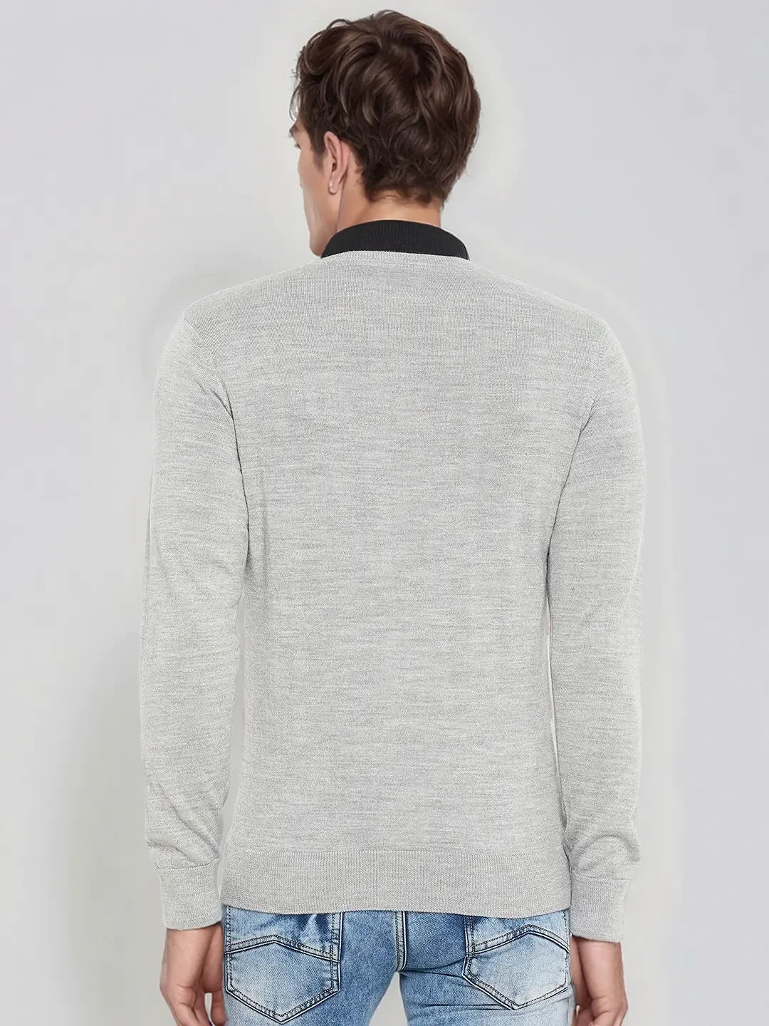 Man in 98degreenorth Men’s Light Grey Merino Wool V-Neck Sweater and blue jeans, seen from behind.