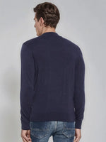 A man models the 98degreenorth Men’s Light Navy Merino Wool Turtle Neck Sweater, back view, against a plain backdrop.