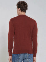 A man in a 98degreenorth Men’s Maroon Merino Wool Turtle Neck Sweater and blue jeans stands with his back to the camera.