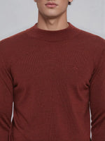 A man wears the 98degreenorth Men’s Maroon Merino Wool Turtle Neck Sweater, shown mid-torso with a small logo.