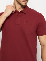 Man in 98degreenorth Men's Maroon Polo, stretch cotton pique, chest pocket, touching collar, mid-torso view.