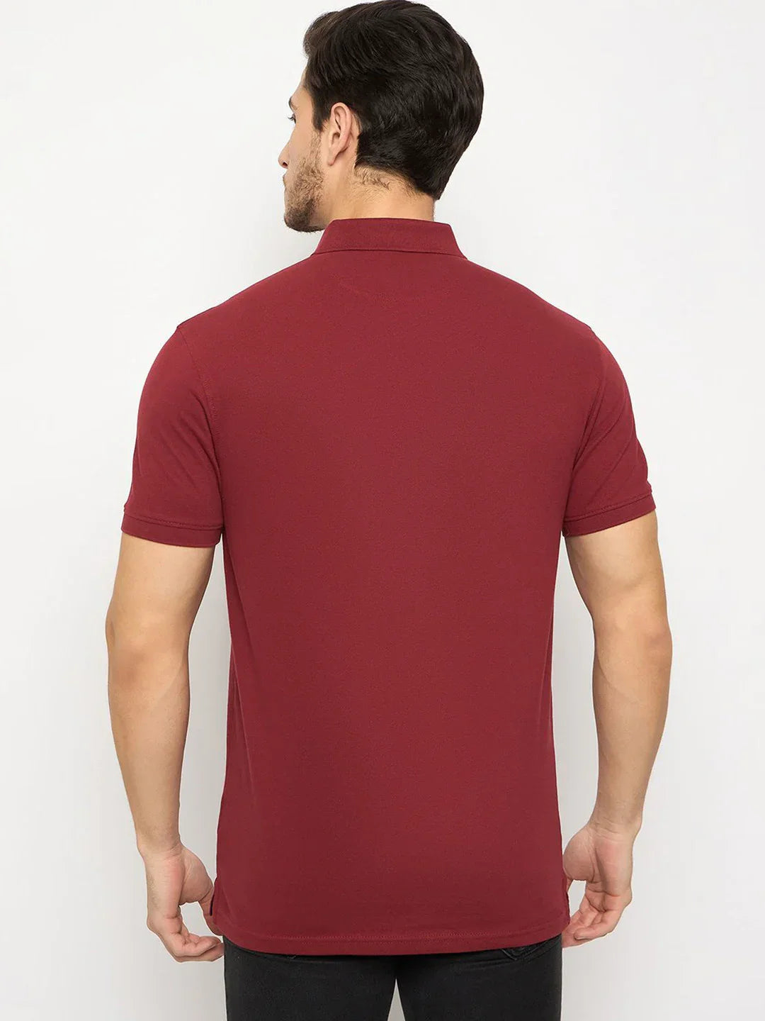 Man facing away in 98degreenorth Men's Maroon Polo—stretch cotton pique with chest pocket, plain background.