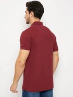 Man facing away in 98degreenorth Men's Maroon Solid Polo T-Shirt — Cotton Pique, paired with blue jeans.