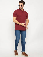 Man in sunglasses wears a 98degreenorth Men's Maroon Solid Polo T-Shirt with blue jeans and brown shoes.
