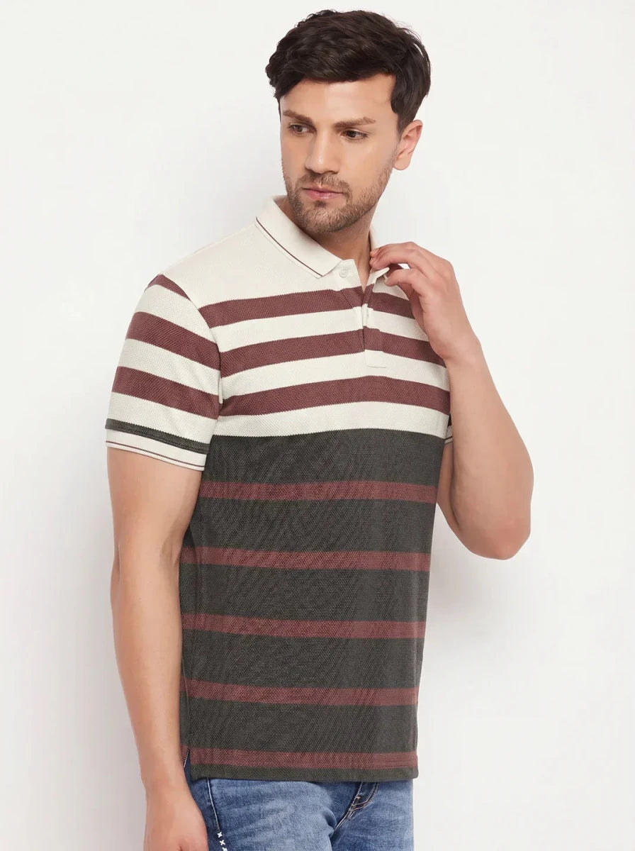 Man in 98degreenorth Men’s Mauve Olive Bold Stripe Pique Polo T-Shirt with blue jeans; soft cotton pique knit.