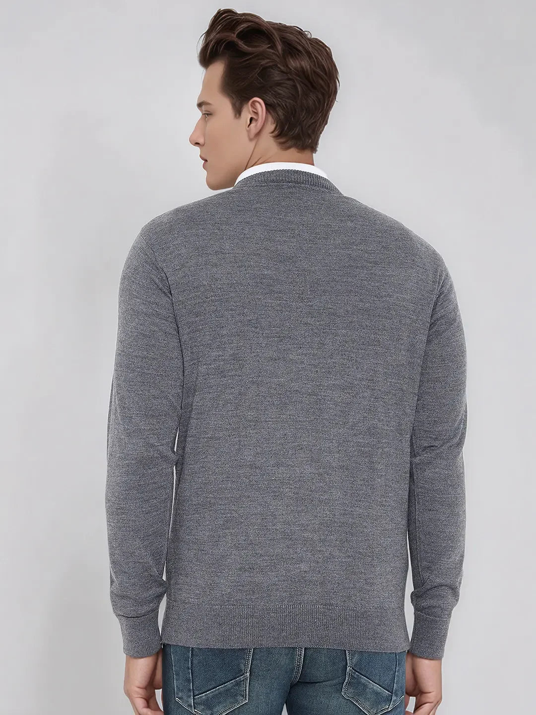 A man wears a 98degreenorth Men's Medium Grey Merino Wool V-Neck Sweater, back to camera, on a light background.