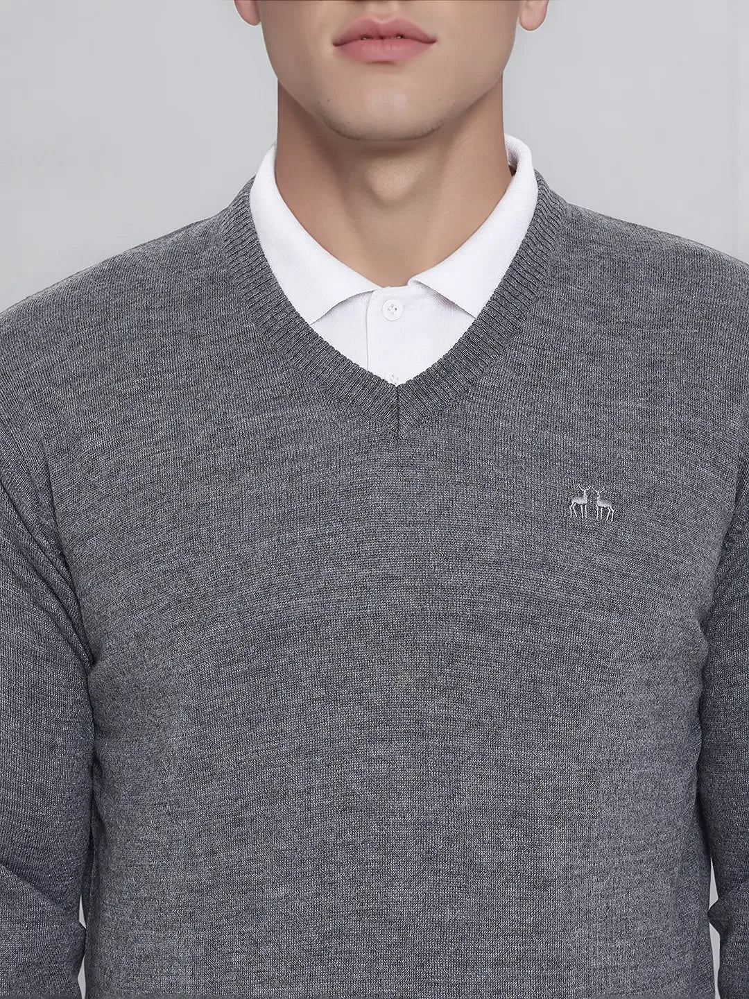 Man in 98degreenorth Men’s Medium Grey Merino Wool V-Neck—a classic corporate pullover for everyday office wear.