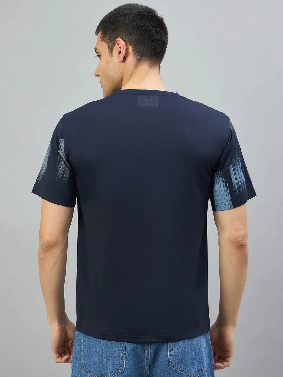 A man in a 98degreenorth Men's Navy Abstract Ikat Print T-Shirt, seen from the back against a gray background.