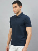 Man wearing the 98degreenorth Men's Navy Blue Quarter Zip Polo T-Shirt, standing against a light grey background.