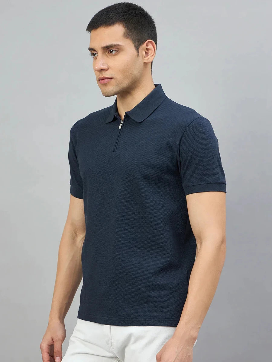 Man wearing the 98degreenorth Men's Navy Blue Quarter Zip Polo T-Shirt, standing against a light grey background.