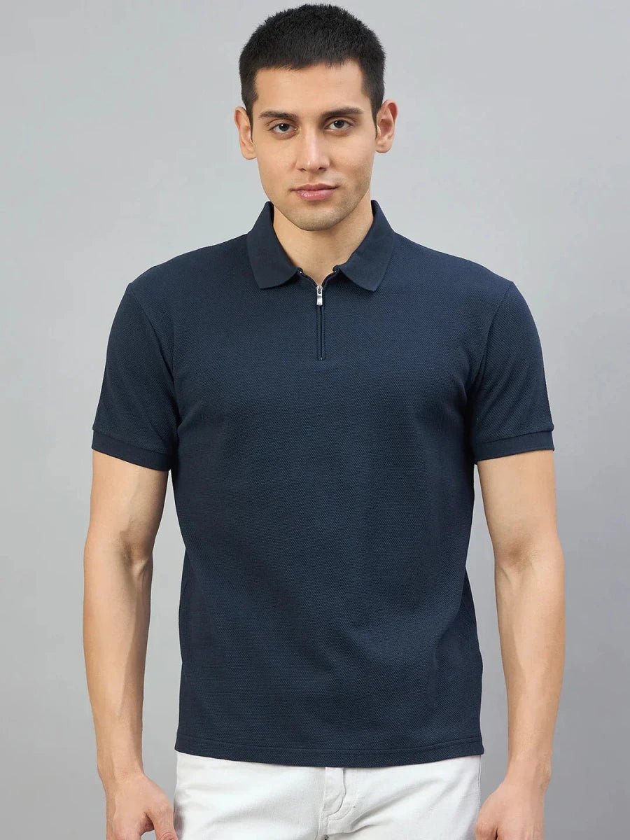 Man wearing 98degreenorth Men's Navy Blue Quarter Zip Polo T-Shirt—Popcorn Knit, against a plain gray background.