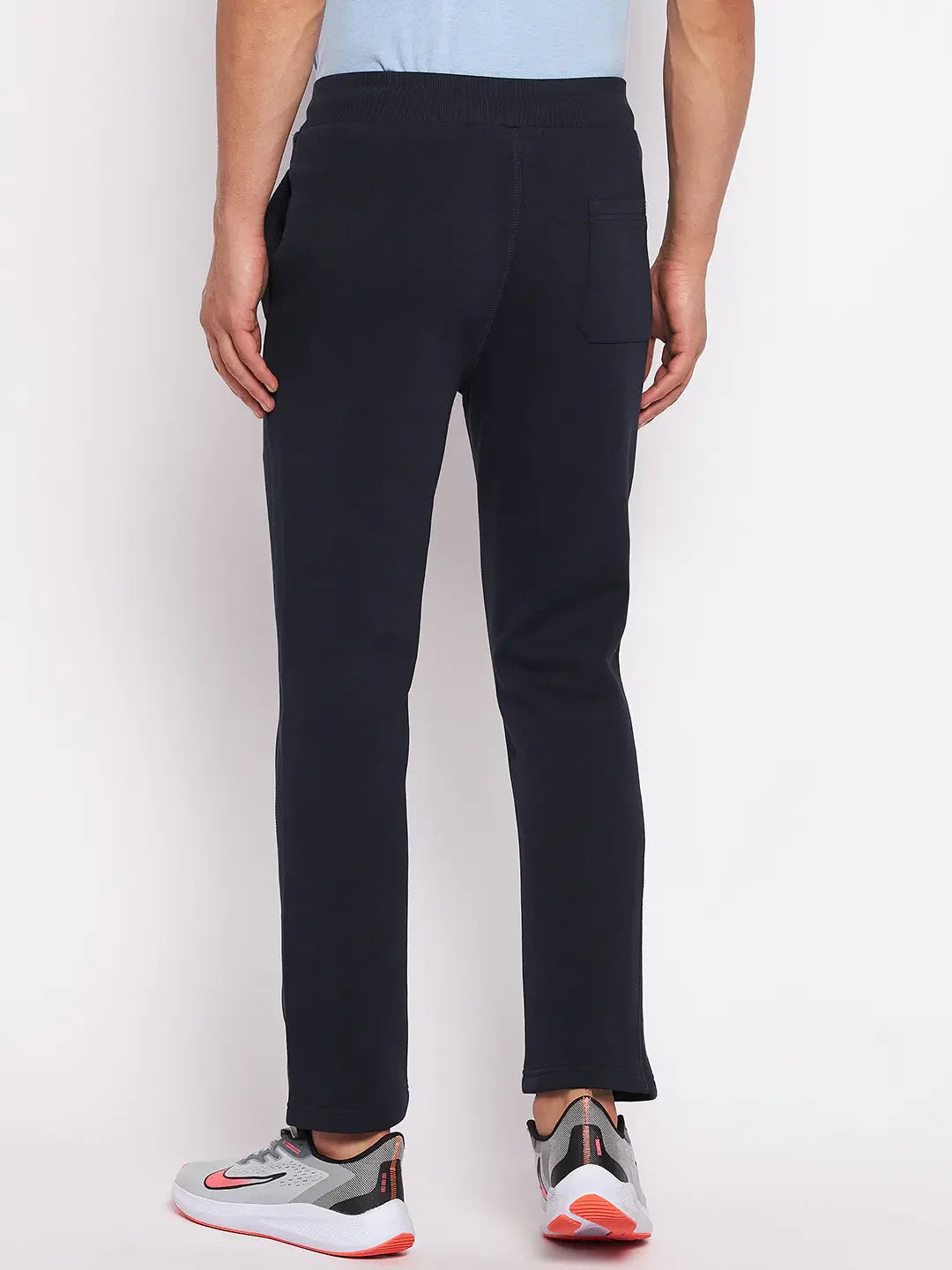 Man in 98degreenorth Men's Navy Fleece Trackpants—classic warm joggers for gym, travel, and winter athleisure style.