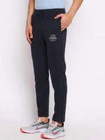Model wears 98degreenorth Men’s Navy Fleece Trackpants – Classic Warm Joggers with gray sneakers, one hand in pocket.